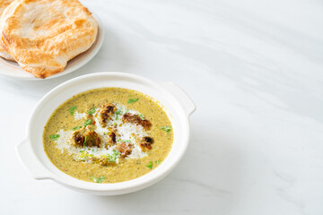 Afghani chicken in green masala curry or Hariyali tikka chicken hara masala with roti or naan bread