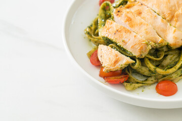 fettuccine spaghetti pasta in pesto sauce with grilled chicken