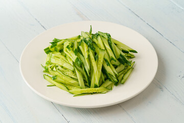 Fresh chopped cucumber isolated on white background