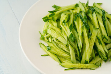 Fresh chopped cucumber isolated on white background