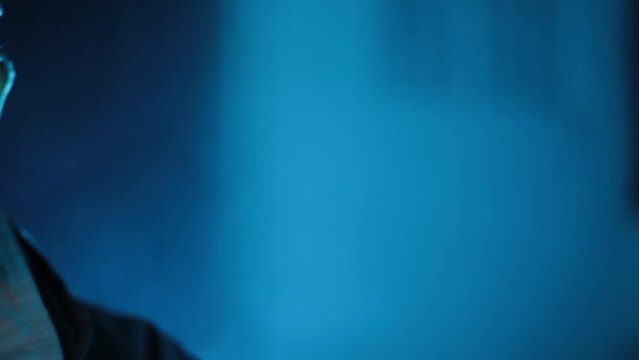 Shadowed Valor - Military Official in Black Jacket with Gun - Intriguing Two-Faced Lighting Technique Adds Drama and Depth - HD Stock Footage. SOC
