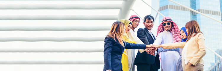Banner Happy Diversity Teams multiethnic Partners standing with hands together in modern city. Panorama Teamwork group of multi racial confident happiness people joining trust teams partners outdoor
