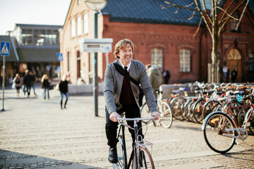 Mature man cycling in the city while commuting to work