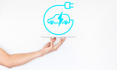 Fototapeta na wymiar EV or electric vehicle icon technology to control, Man hand with digital tablet, Blue HUD car interface Electric car with plug icon symbol, EV car, Green hybrid vehicles charging.