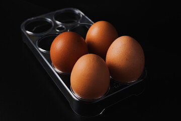 eggs in a box basket on a black background