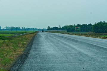 view of wet rainy road in a village in India