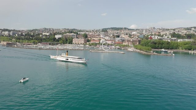 Aerial of beautiful old cruise ship with the skyline of the city Lausanne, Switzerland in the background