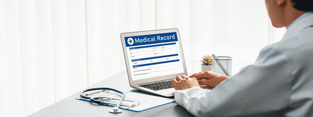 Doctor carefully review detailed medical report on laptop and diagnosing illness for effective...