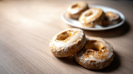 A pile of round gingerbread cakes sprinkled with powdered sugar. Warm, homely defocused background with space to copy.