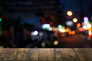 Empty dark wooden table in front of abstract blurred boken bankground of restaurant. Can used for display or montage your products. Mock up for space.