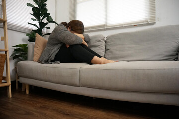 Sad Young woman. Young woman at home living room sofa feeling sad tired.Young woman depressed...