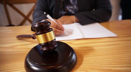 Legal counsel presents to the client a signed contract with gavel and legal law. Justice and lawyer...