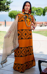 beautiful young peruvian woman of the yanesha culture posing with dresses, jewelry, makeup, clothes...