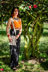 beautiful young peruvian woman of the yanesha culture posing with dresses, jewelry, makeup, clothes...