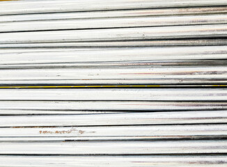 Close-up of Pile of Round bar steel. Pile of round metal pipes at a construction site. Storage steel tube industrial materials on warehouse.
