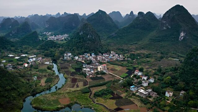 Aerial shot of the amazing rock formations rural towns near the Li River in Yangshuo County China. Hazy day.
