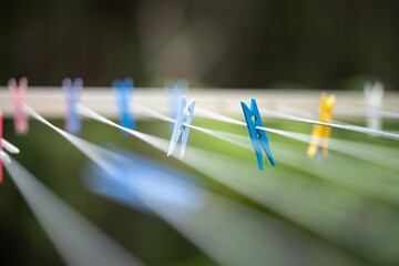 colored pegs on clothes line outside of a house