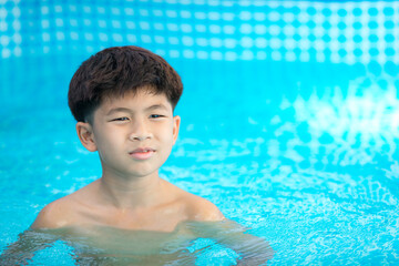 Shirtless boy playing in the pool