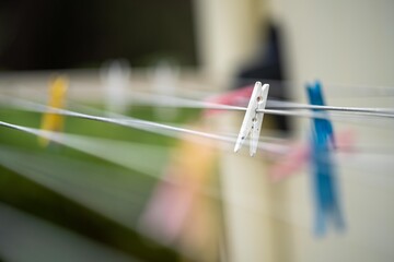 colored pegs on clothes line outside of a house