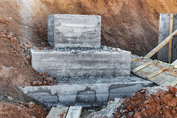 Monolithic reinforced concrete foundation for the construction of a residential building. Rostverk at the construction site. Construction pit with foundation after formwork removal.