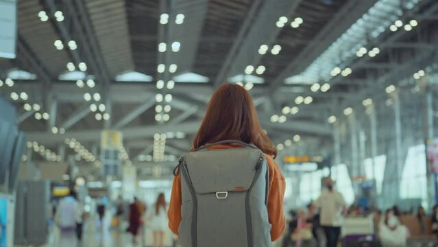 Woman with backpack walking at Airport Terminal, Tourist journey trip concept
