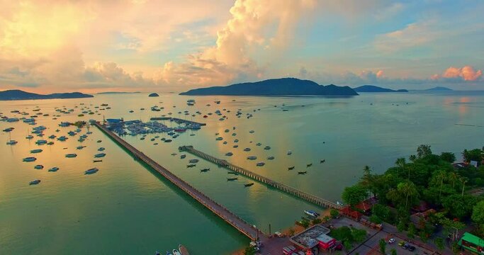 .High angle view colorful cloud above Chalong pier..a lat of boats are parking in Chalong marina. .Majestic sunrise landscape scenery two piers in green sea..Amazing light of nature cloudscape.