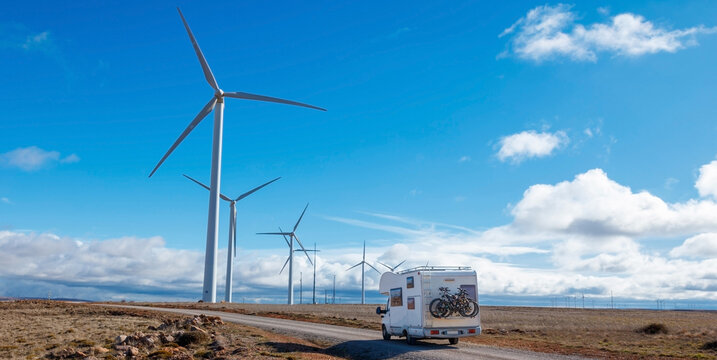 motorhome on the road of wind turbines