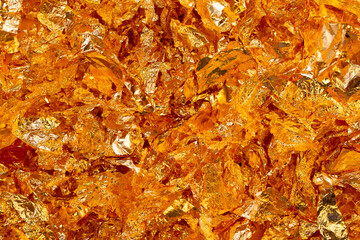 Golden texture background. Golden potal close-up glitters and shimmers. Golden holiday background.