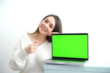 Young woman holding laptop with success. High quality photo
