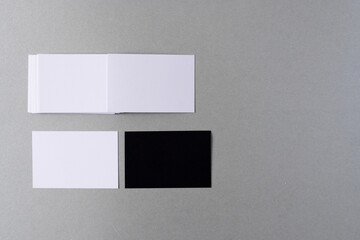 White and black business cards with copy space on grey background