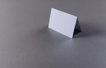 White business card with copy space on grey background