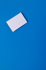 White business card with copy space on blue background
