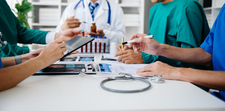 Medical technology network team meeting concept. Doctor hand working with smart phone modern digital tablet and laptop computer with graphics chart interface, with virtual icon diagram