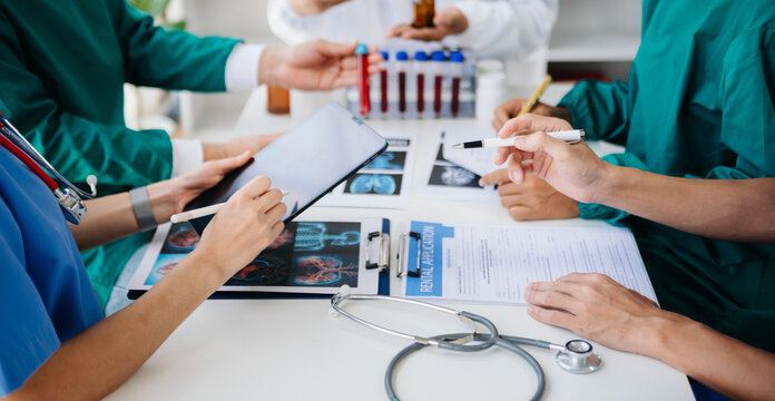 Medical technology network team meeting concept. Doctor hand working with smart phone modern digital tablet and laptop computer with graphics chart interface, with virtual icon diagram