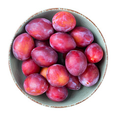 Ripe plums in a bowl isolated on white background. Top view. File contains clipping path.