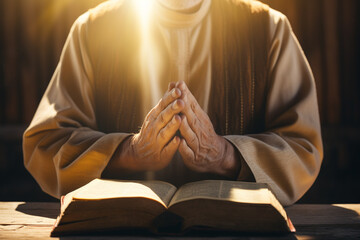 Culture and religion concept. Close-up view of praying priest hands with bible and illuminated sunlight beams. Generative AI