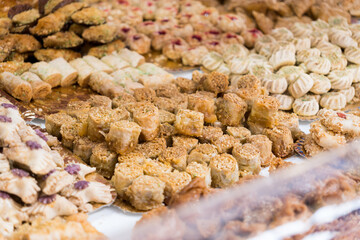 Sweets and puff pastry treats. Typical desserts from Arab cuisine. Trays with puff pastry treats and cookies.