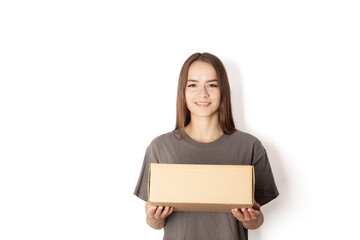 young woman courier with a box parcel on a white background, a teenager girl holds an order in her hands in a package, delivery of goods online