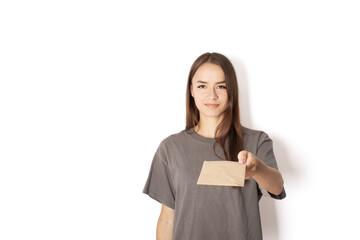 young woman postman with a letter on a white background, postal courier with documents in an...