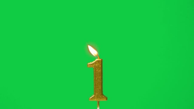 seamless looping candle light, golden candle number one shape for first year celebrate was lit. flame at candlewick sway and flicker isolated on green screen background, horizontal frame rate 60P