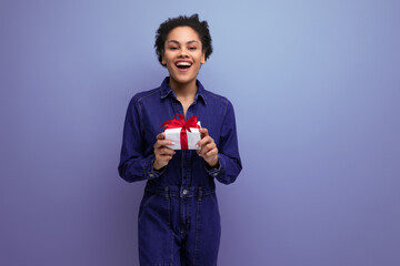 young slender brunette latin woman dressed in blue denim overalls received a birthday present