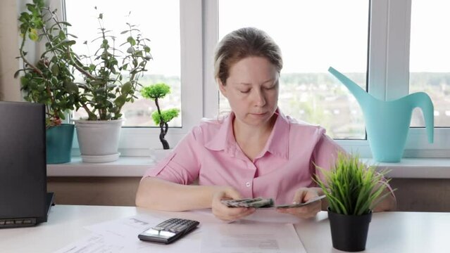 woman counting money at her desk, profit, interest, dividends, passive income, stock exchanges, income growth, money contract, financing, opening a bank account, tax