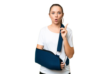 Young blonde woman with broken arm and wearing a sling over isolated chroma key background...