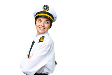 Airplane pilot woman over isolated chroma key background with arms crossed and happy