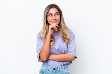 Young Uruguayan woman isolated on white background thinking an idea while looking up