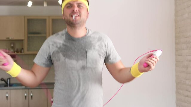 Funny man with a cigarette in his mouth smoking and jumping rope. A humorous shot about smoking and sports