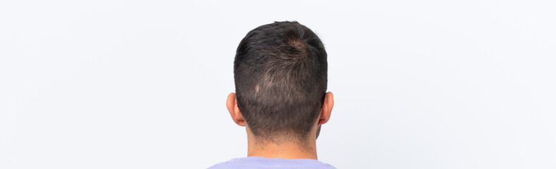 Obraz premium Young caucasian man isolated on white background in back position