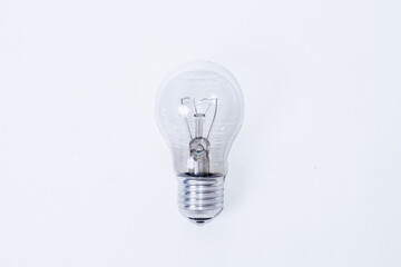 Faulty incandescent light bulb on white background
