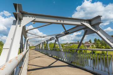 Bolts and nuts on metal plates of steel structure of heavy duty straight crossbar of frame and bridge support