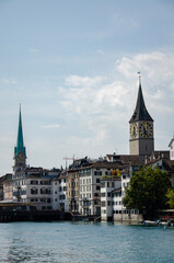 View of some typical Swiss houses and St. Peter and Fraumünster churches at the edge of the Limmat, the river in Zurich
